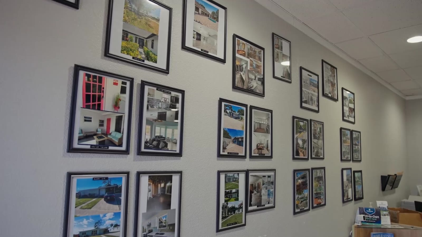 Wall of before-and-after project photos in the Prather office