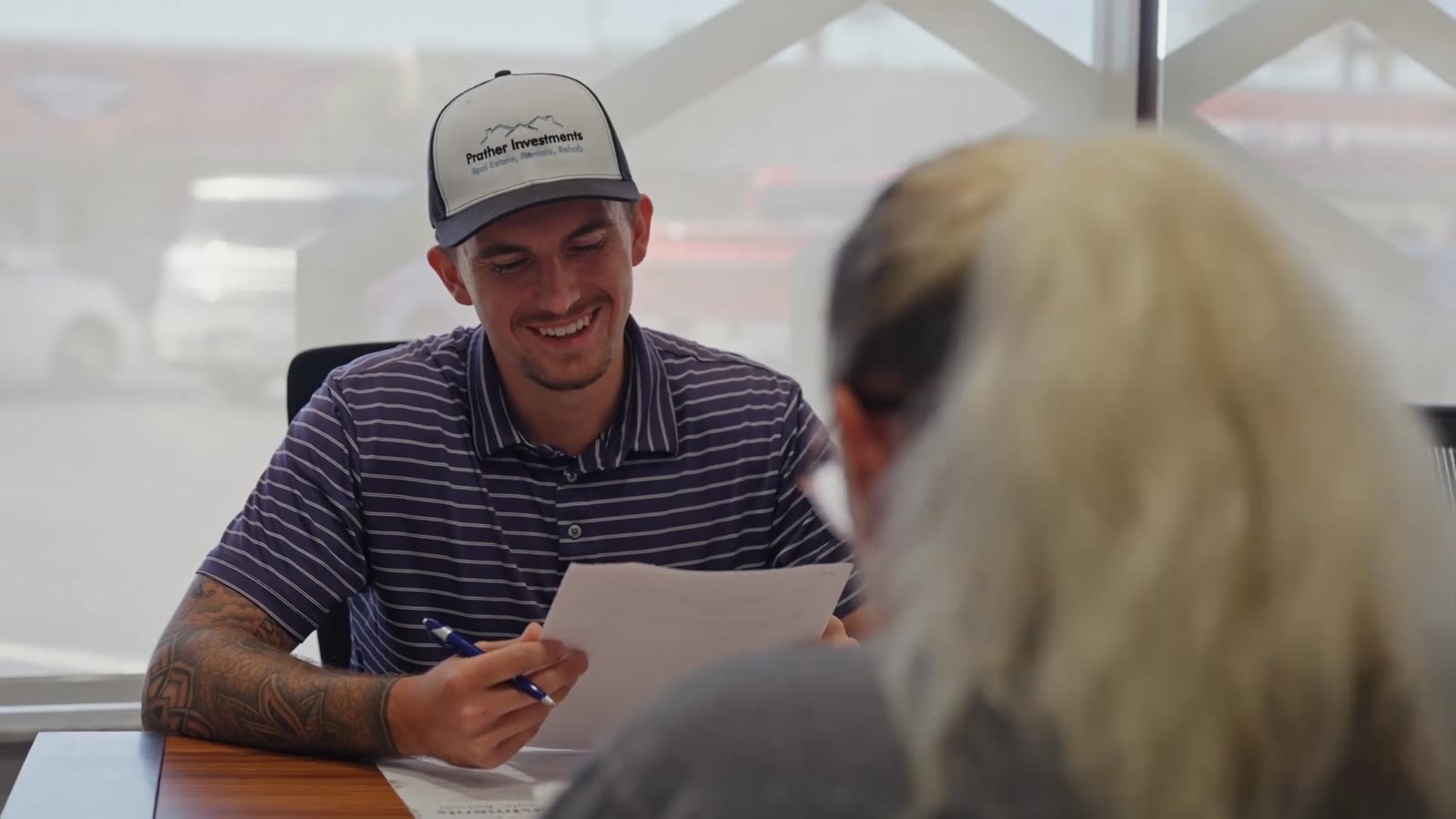 Jake Waelti going over paperwork with a homeowner